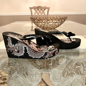 Bebe black wedges with dragon detail.